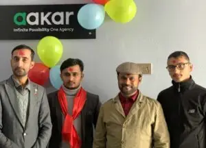 Team photo at Aakar Creative Hub's opening ceremony with festive decorations.